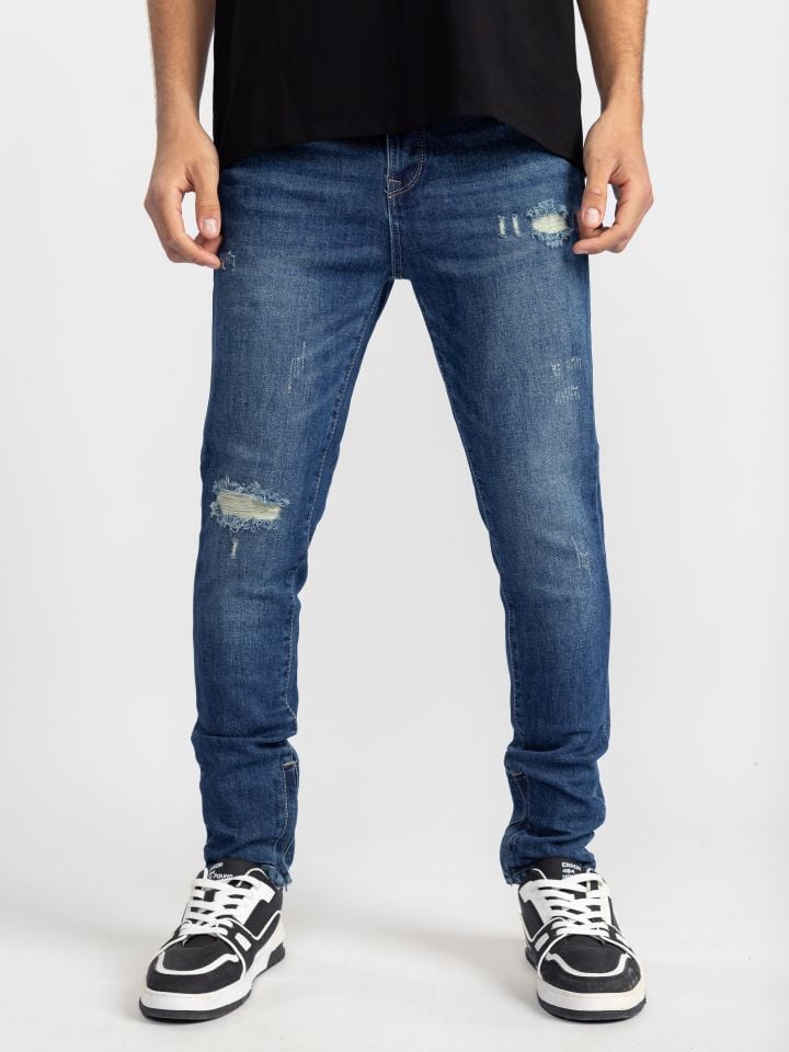 גינס סקיני עם קרעים ורוכסנים בסיומת