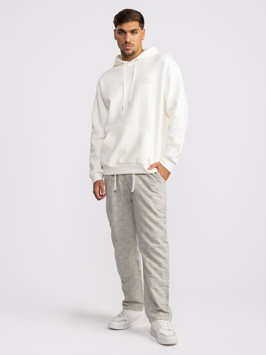 מכנסי ג’’ינס עם טקסטורת משבצות מובלטת