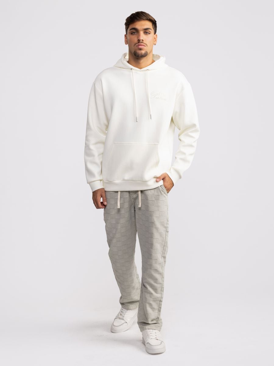 מכנסי ג’’ינס עם טקסטורת משבצות מובלטת